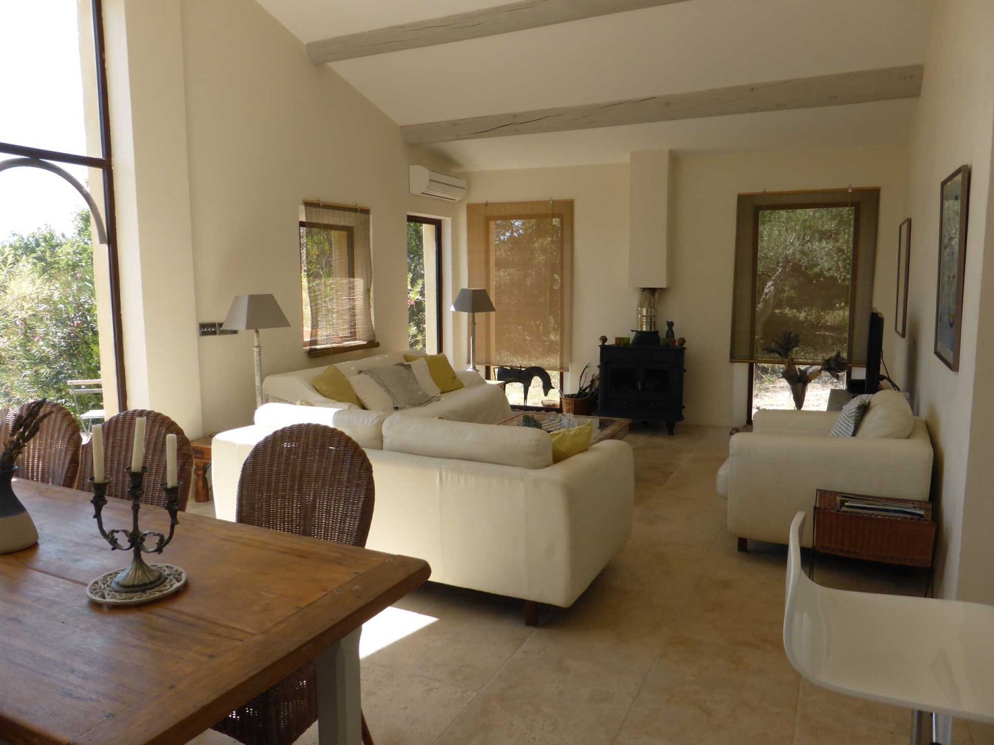 Airy open-plan living and dining room with limestone floors at La Maison de Lune, ideal for summer in Provence